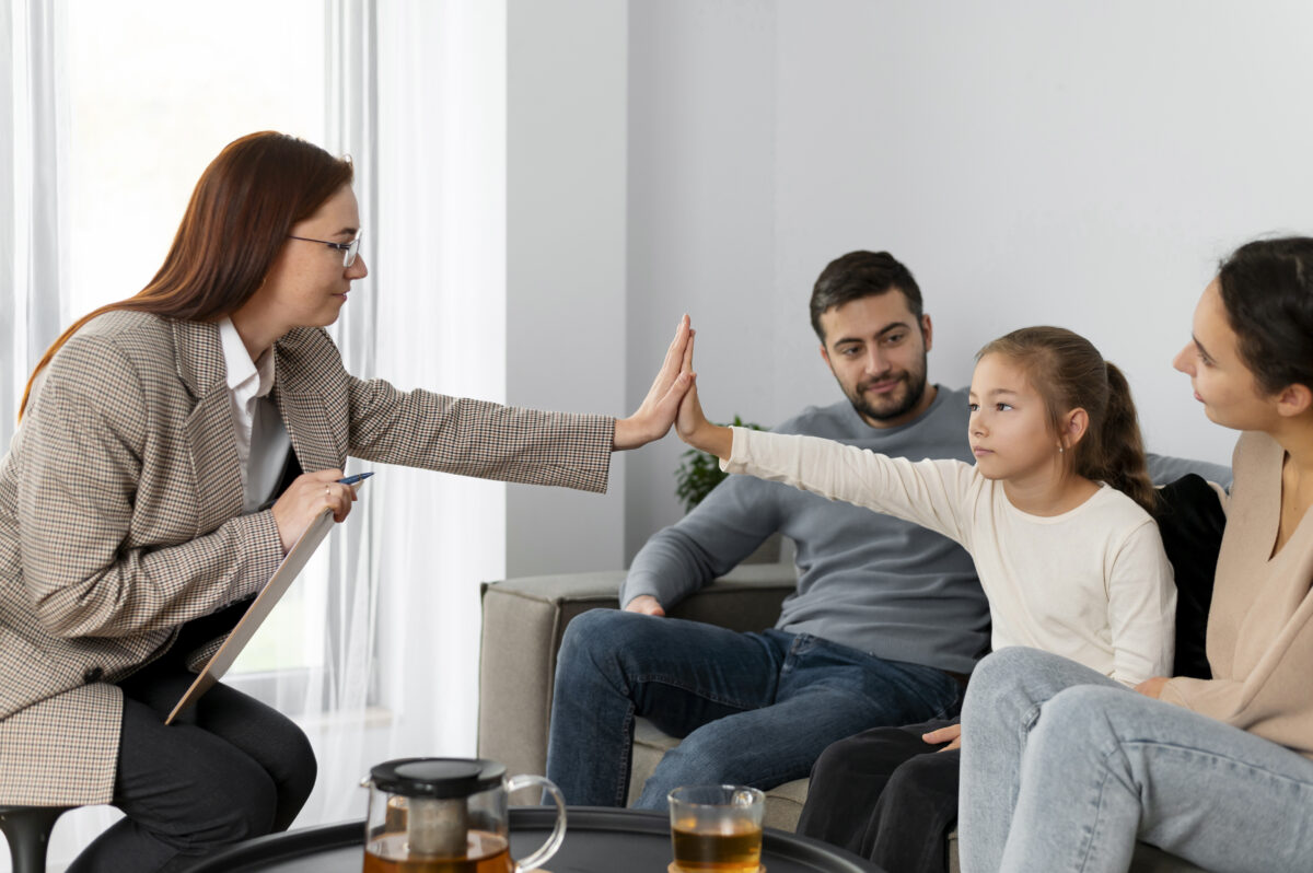 close-up-girl-therapist-high-five-1200x798.jpg